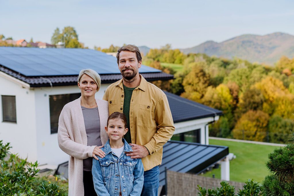happy-family-near-their-house-with-solar-panels-a-2023-11-27-05-28-34-utc